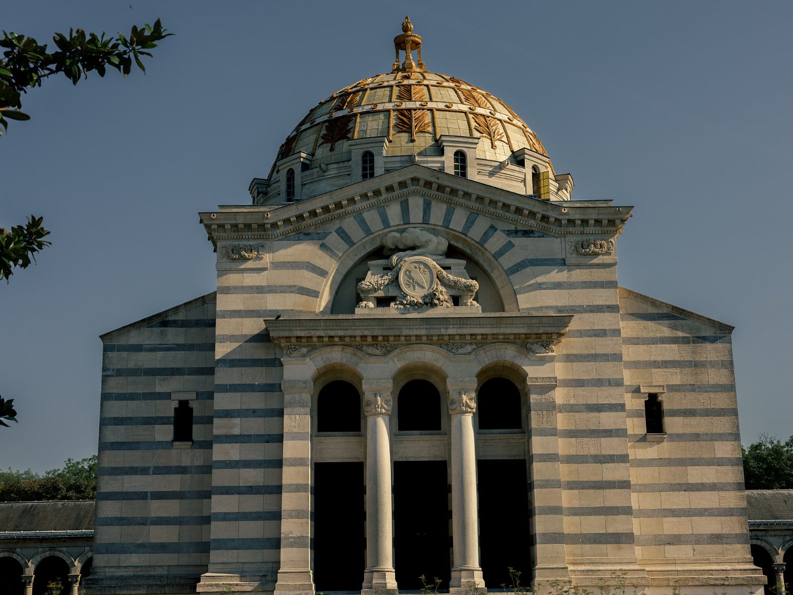 The banded stone façade and gilded dome of the crematorium above the columbarium