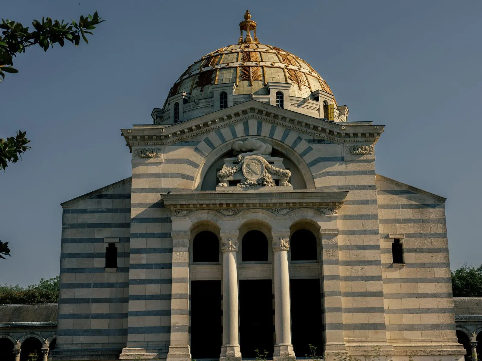 The banded stone façade and gilded dome of the crematorium above the columbarium