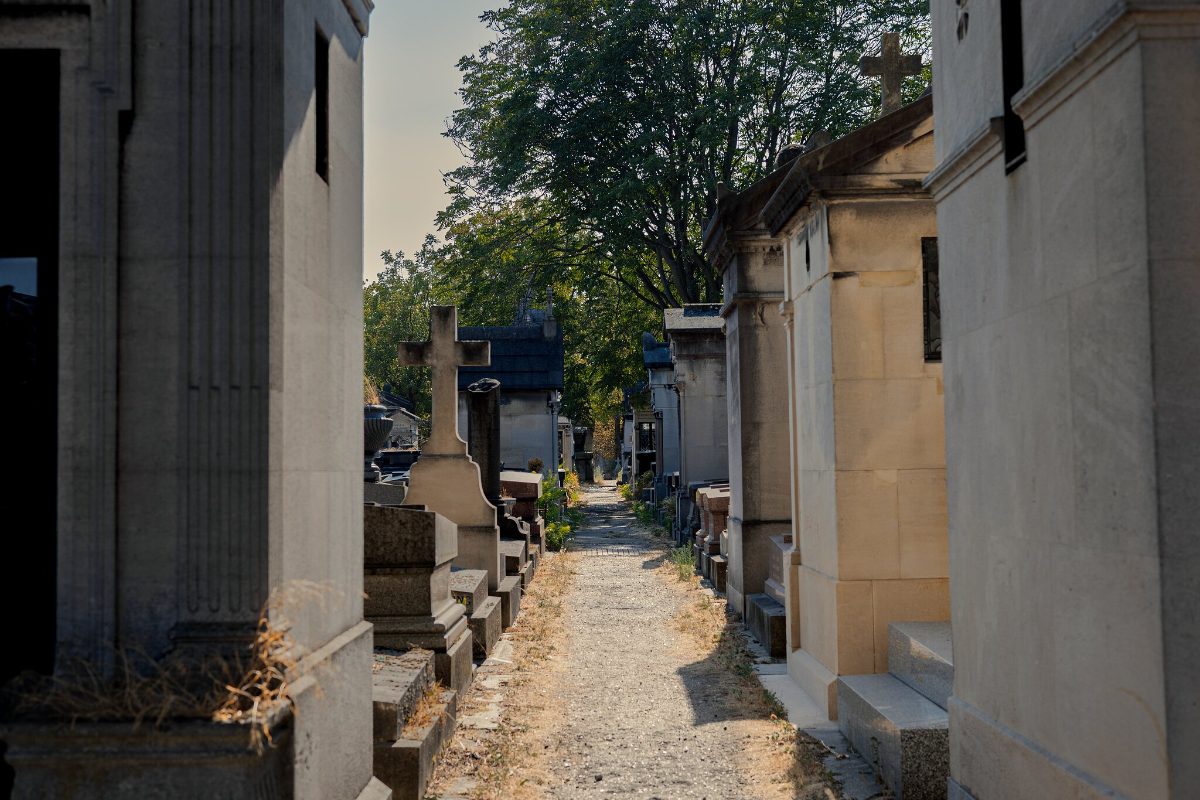 A narrow gravel path running between the walls of family vaults